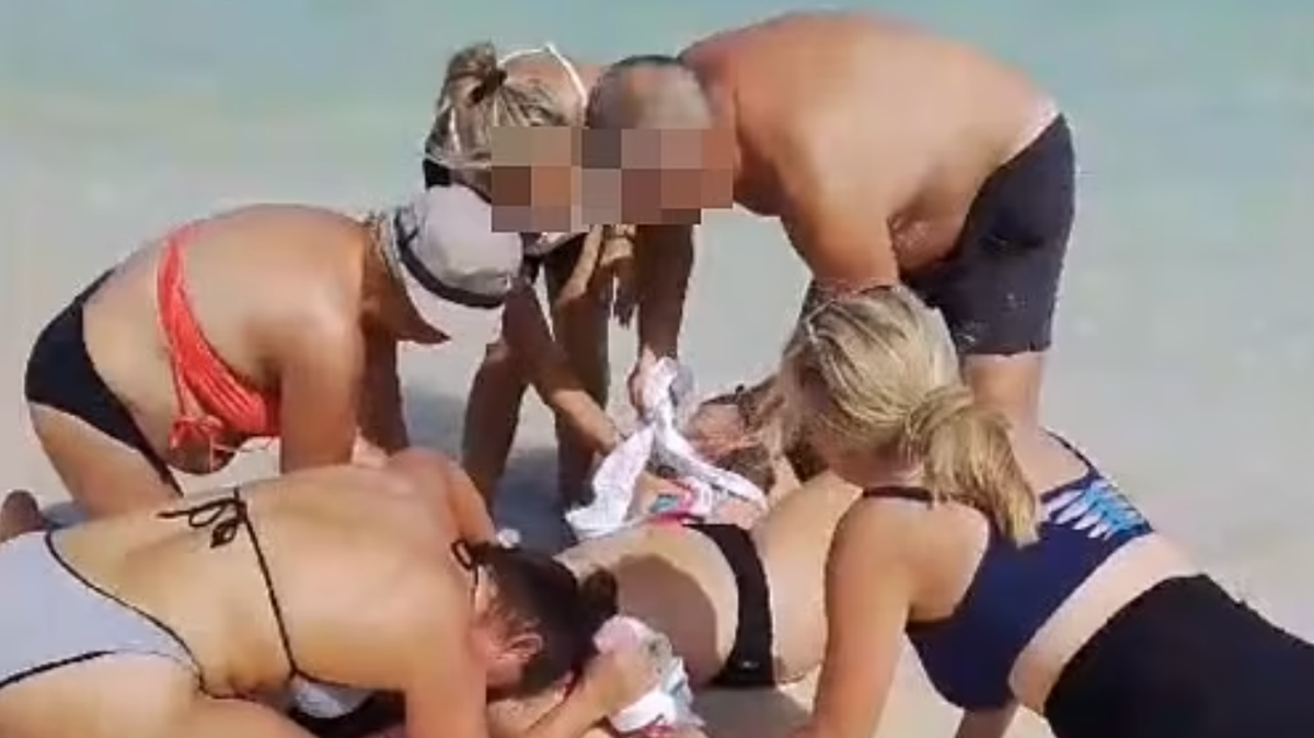 Witness reveals horrifying thing they saw after woman's hands were bitten off by shark she 'tried to take photo of'