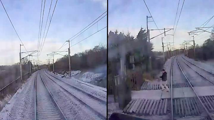 令人震惊的视频显示时刻人在越过轨道时几乎被火车击中