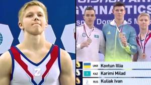 俄罗斯体操运动员在乌克兰运动员旁边的领奖台上戴着“战争符号”