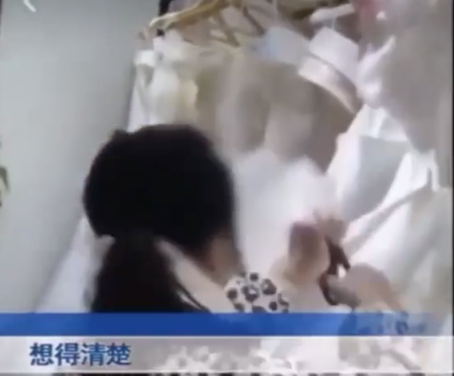 The woman snipped through white bridal gowns (Credit: Twitter/Sohu)