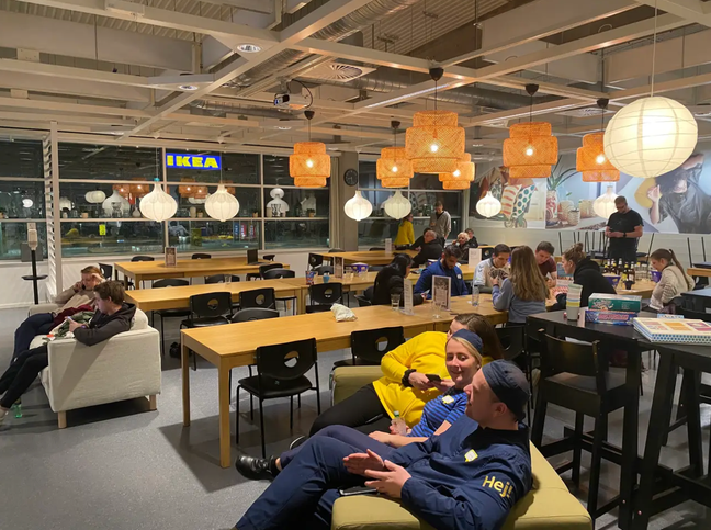Members of staff and customers making the most of their time stuck inside IKEA. Credit: Peter Elmose