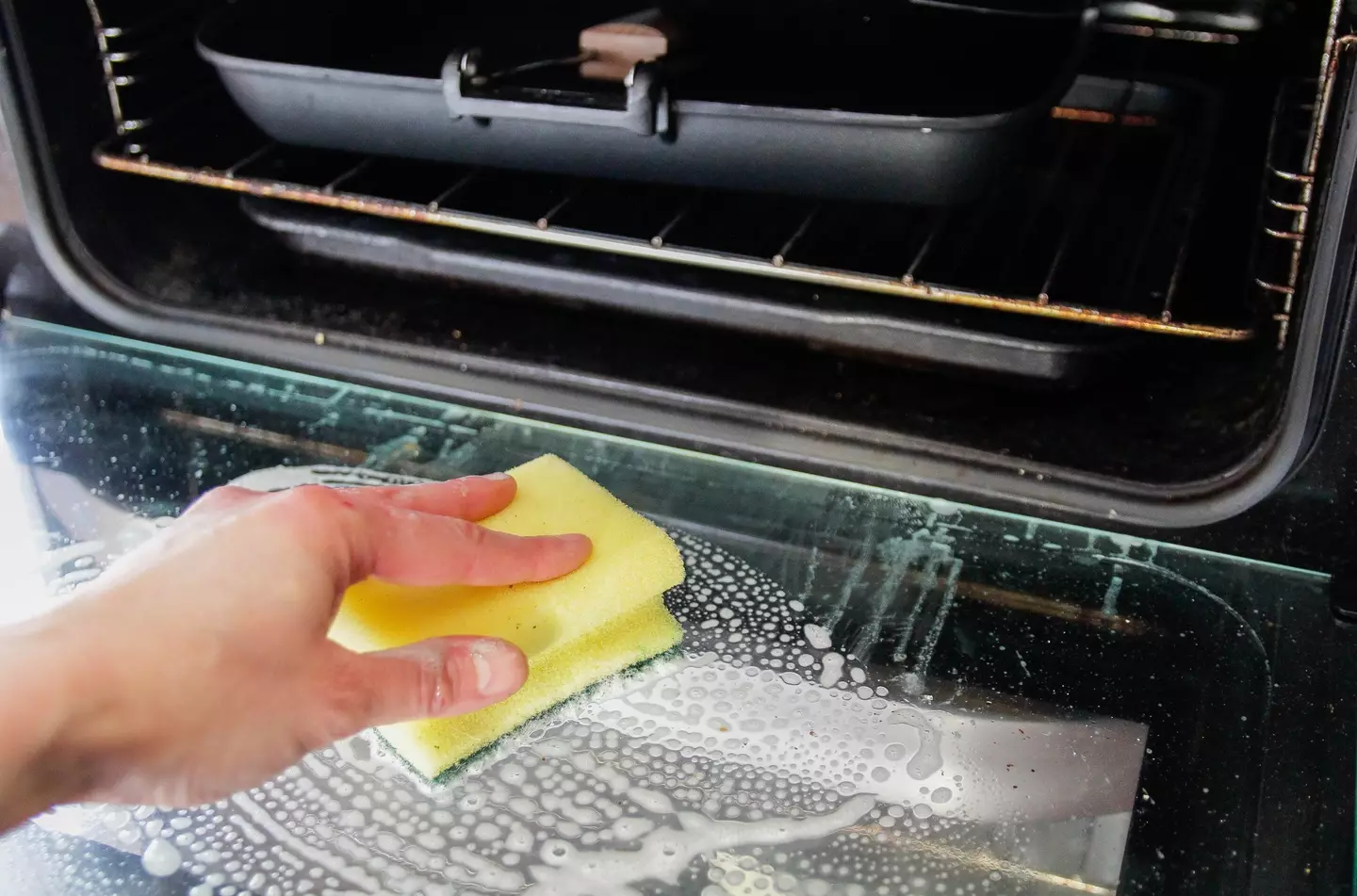 Cleaning the oven is arguably the worst job. (Kinga Krzeminska/Getty Stock Image)