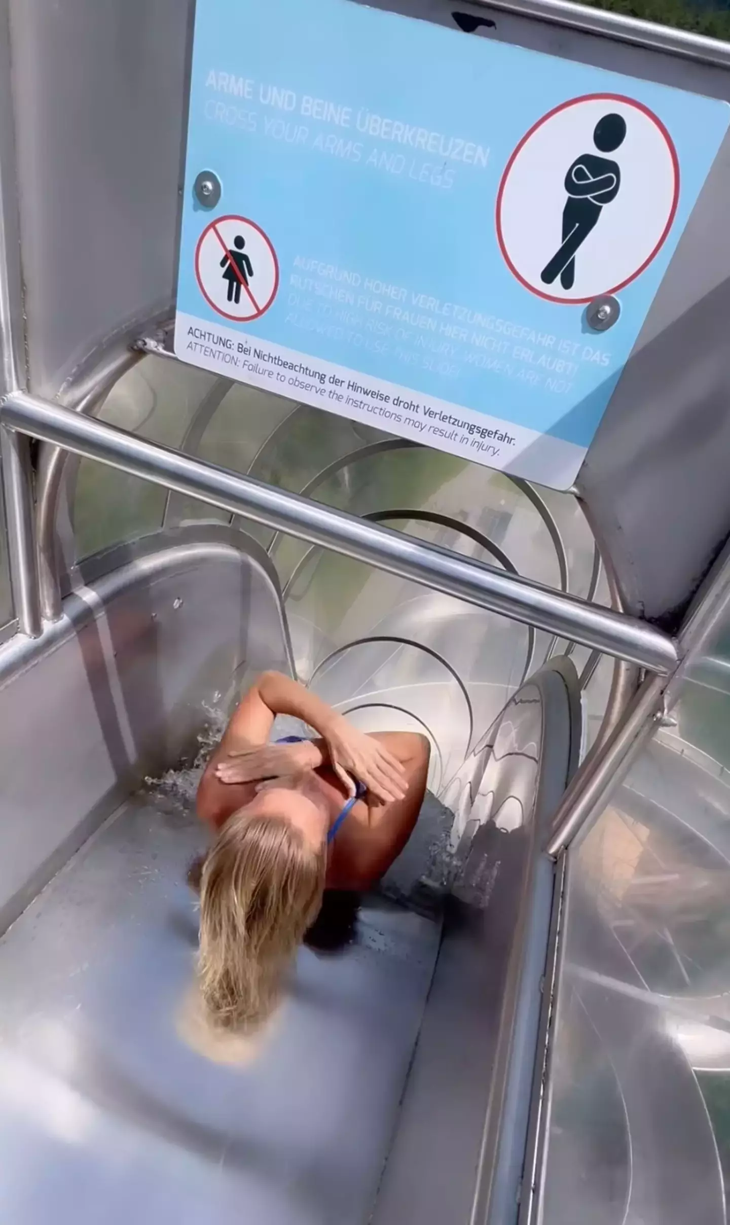 Seven-time world champion cliff diver, Rhiannan Iffland, ignored the sign and went down the 'male-only' slide. (Instagram/@rhiannan_iffland)