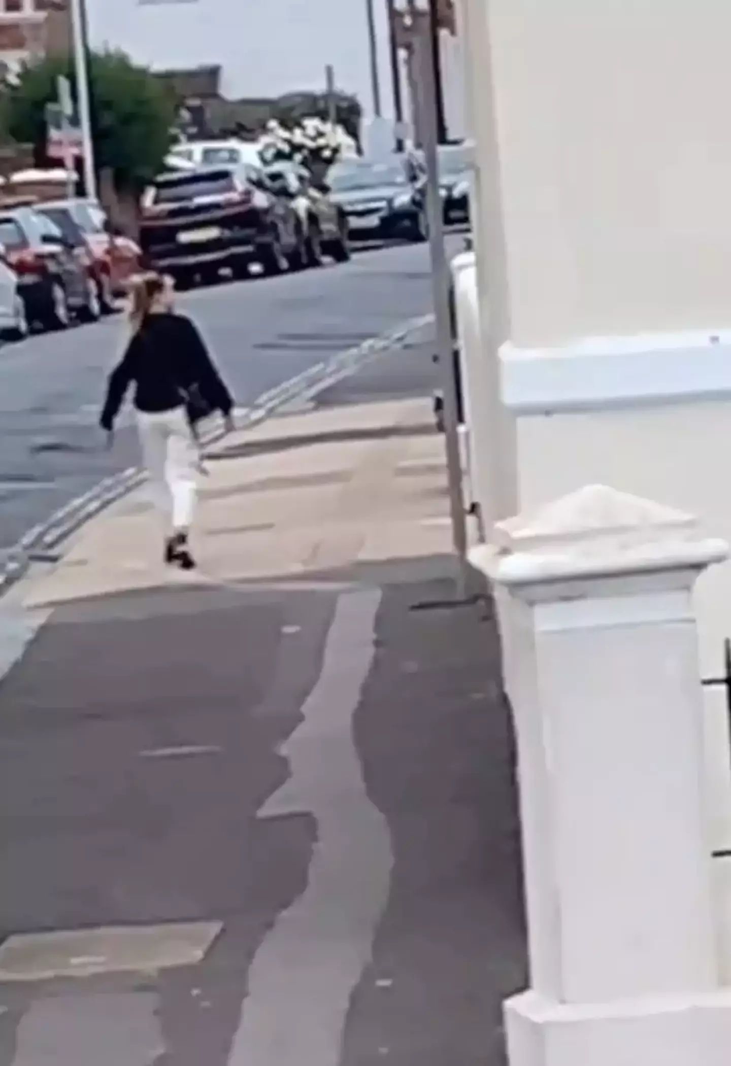 The viral TikTok shows a 'frozen' woman standing in the middle of the street.