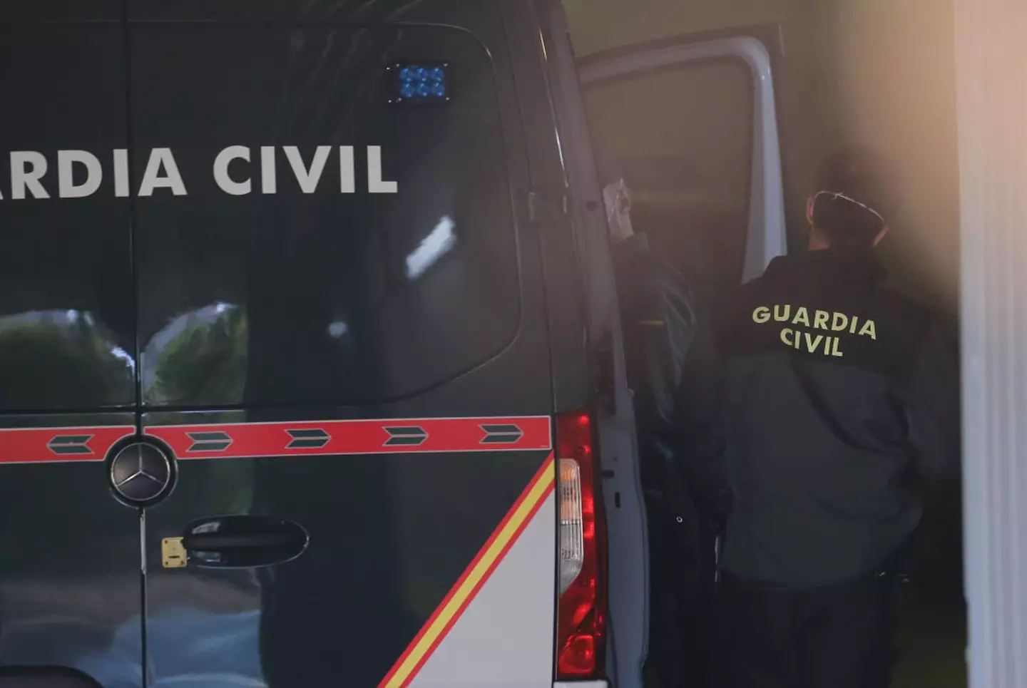 A Guardia Civil officer taking Cesar Roman Viruete out of a police van to testify at trial. (Isabel Infantes/Europa Press via Getty Images)
