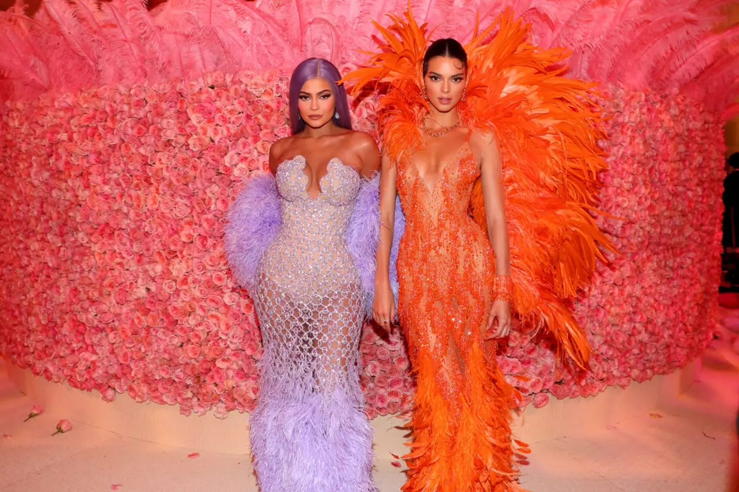 Kendall and Kylie Jenner in feathered Versace designs at the 2019 Met Gala. (Kevin Tachman/MG19/Getty Images for The Met Museum/Vogue)
