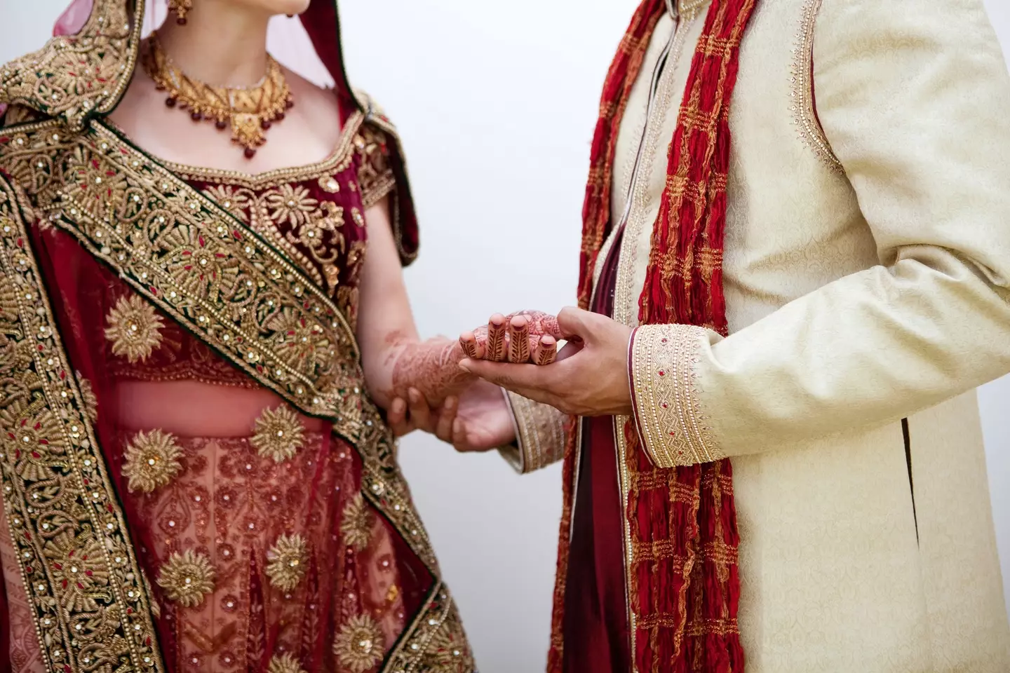 Bride and groom in traditional Indian wedding clothing.