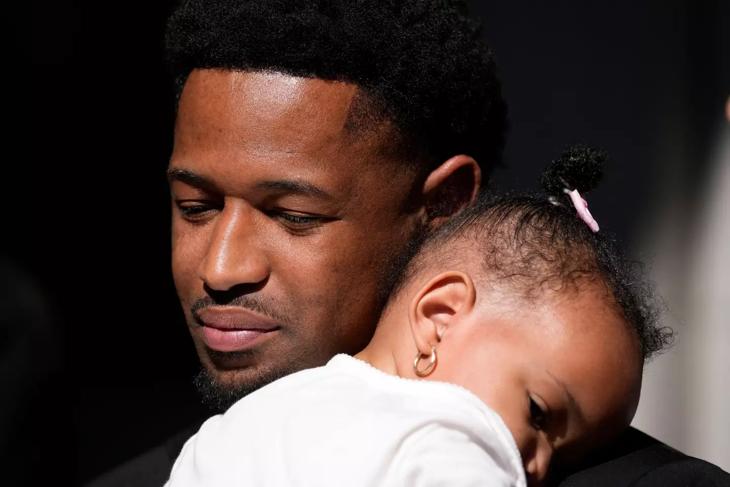 Dupree Glass hugs his daughter Amill after a hearing on his case on Thursday.