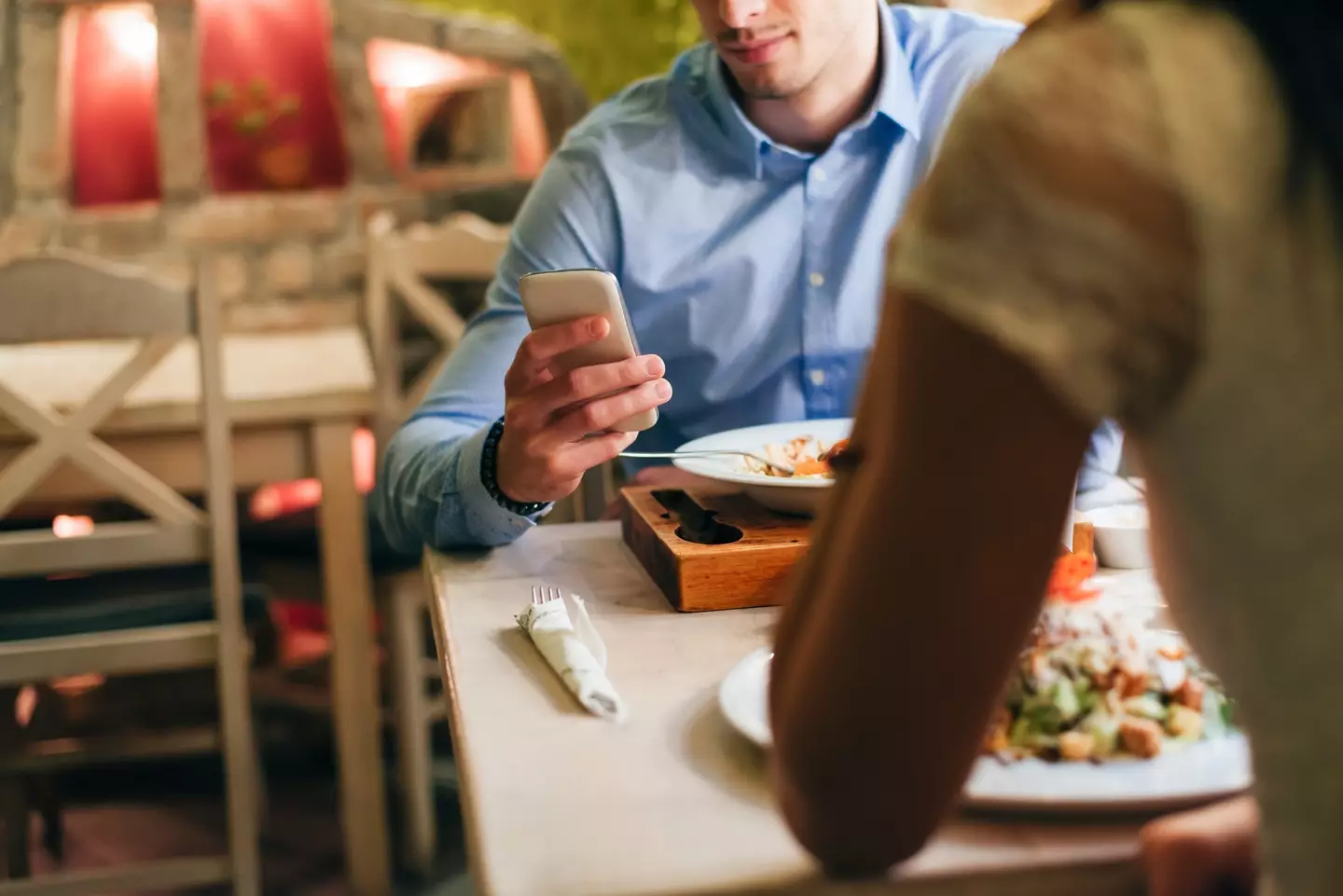 Looking at your phone while on a date is a huge no go (Westend61/Getty Stock)