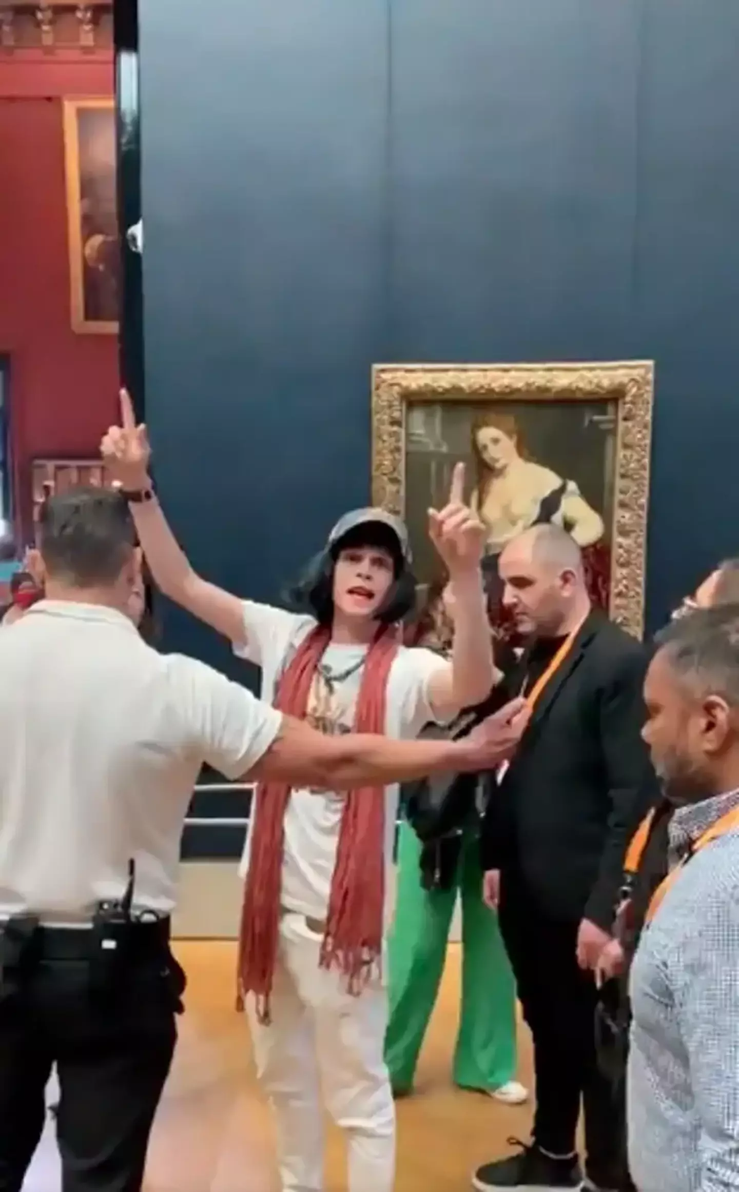 And this year, a man decided to hurl cake at the painting before being led away by security.