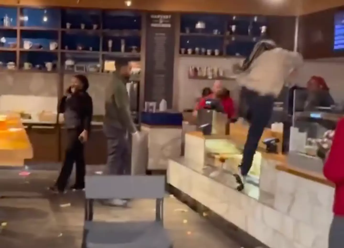 The employee leaps over the counter.