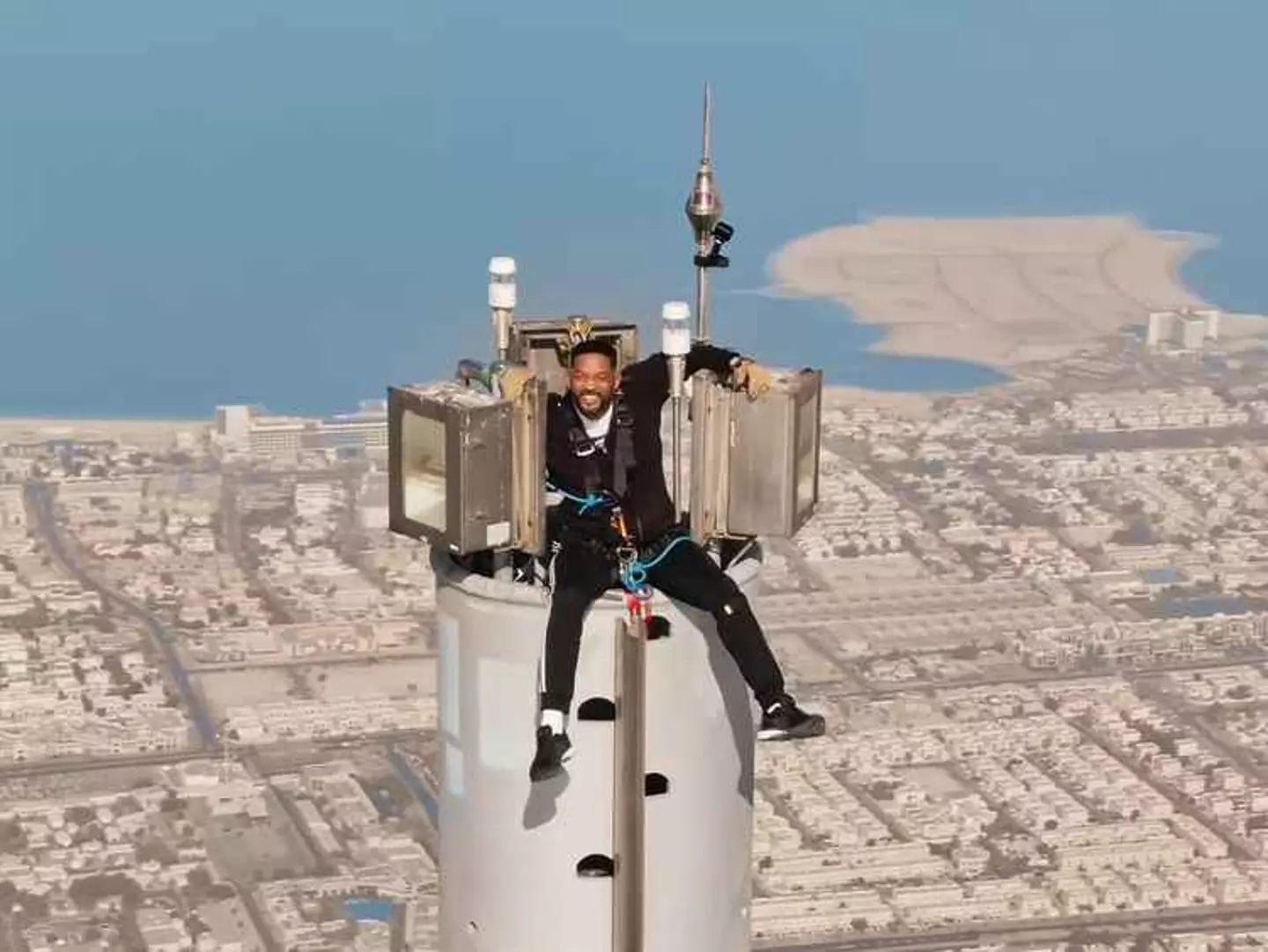 Will Smith on top of the Burj Khalifa, looking like he's slightly losing his mind. (YouTube)