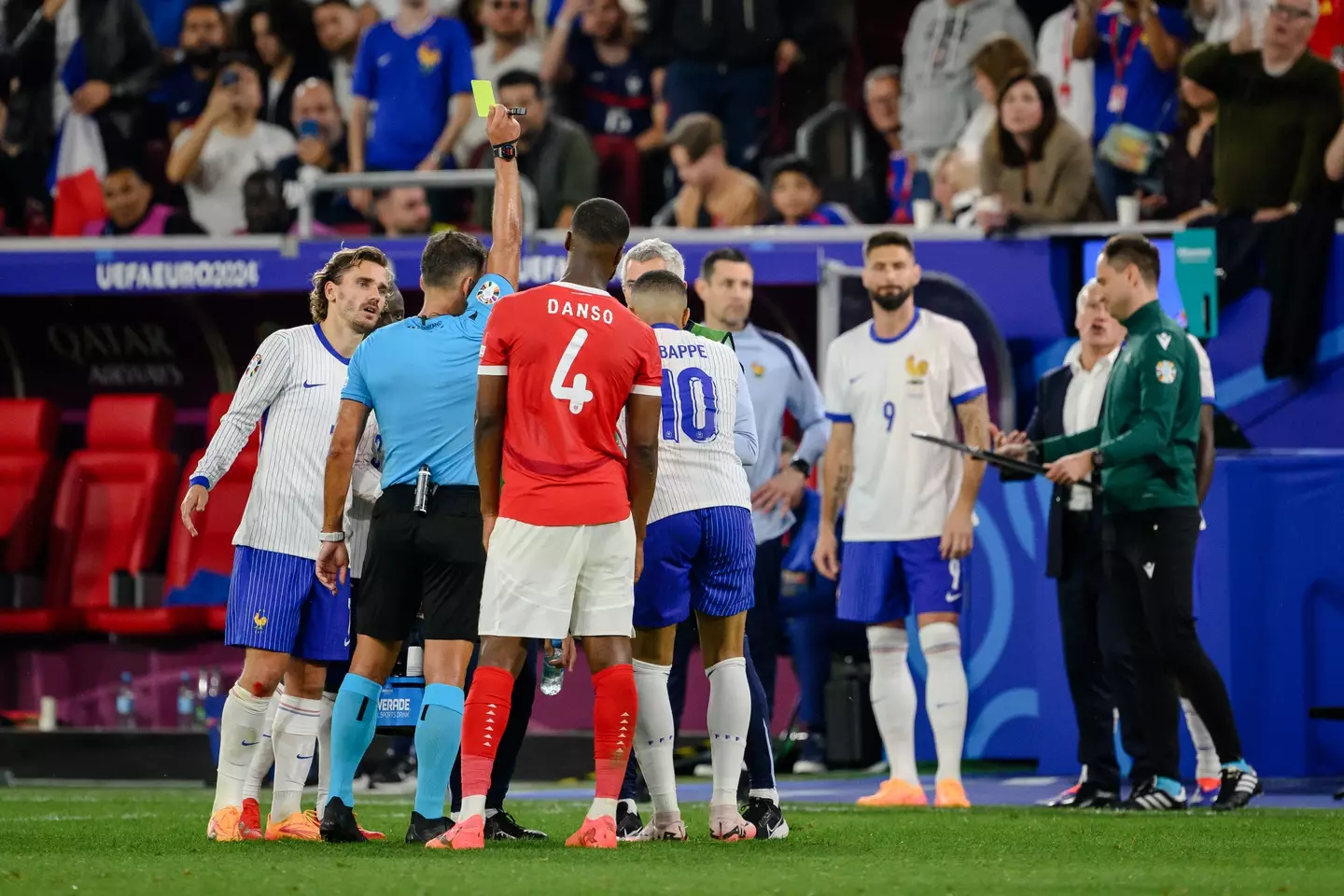 Gil Manzano shows a yellow card to Kylian Mbappe at Euro 2024. Image: Getty