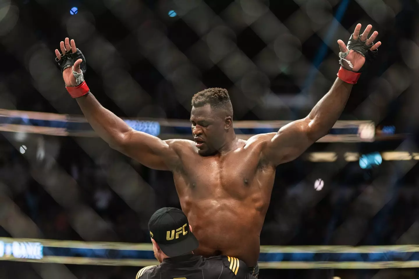 Francis Ngannou raised by his coach after beating Ciryl Gane. Image: Alamy 