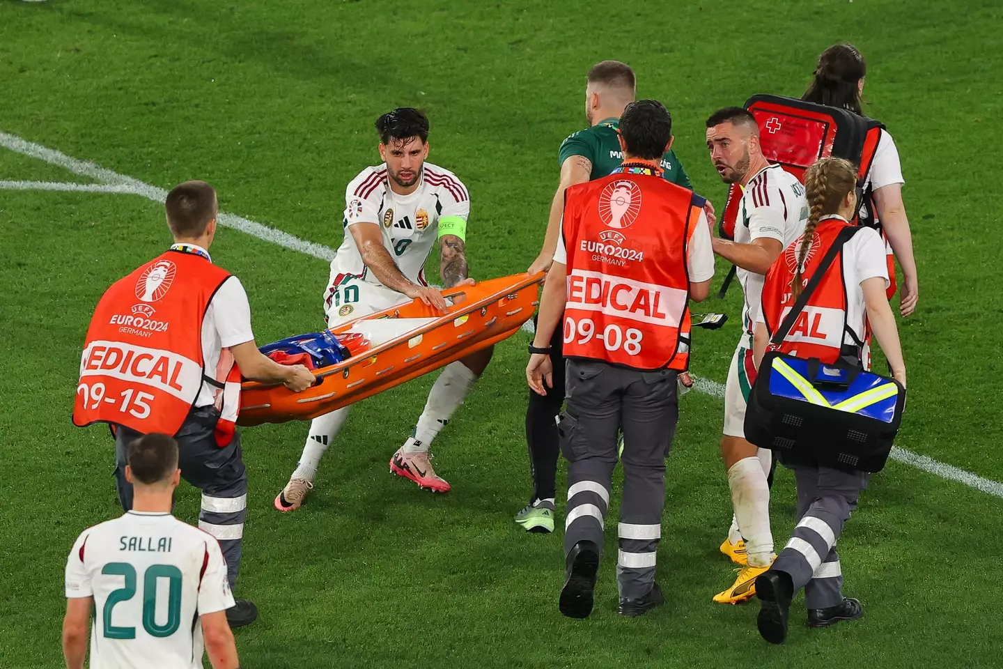 Dominik Szoboszlai assists the medical team following Barnabas Varga's incident. Image: Getty