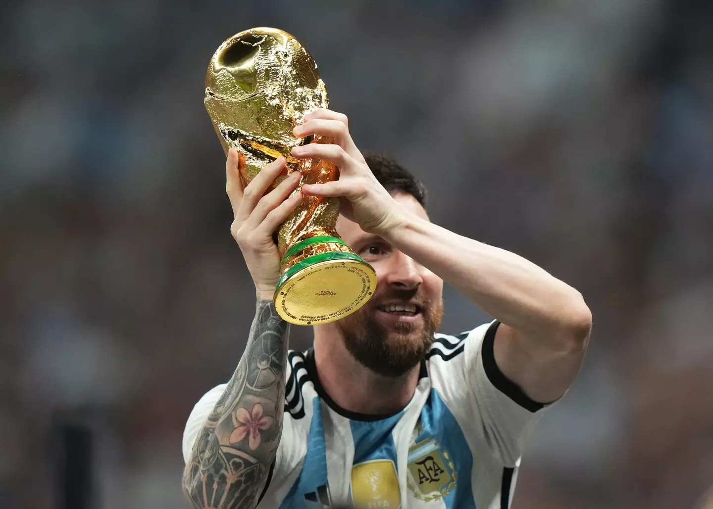 Paris Saint-Germain superstar Lionel Messi lifting the World Cup with Argentina.