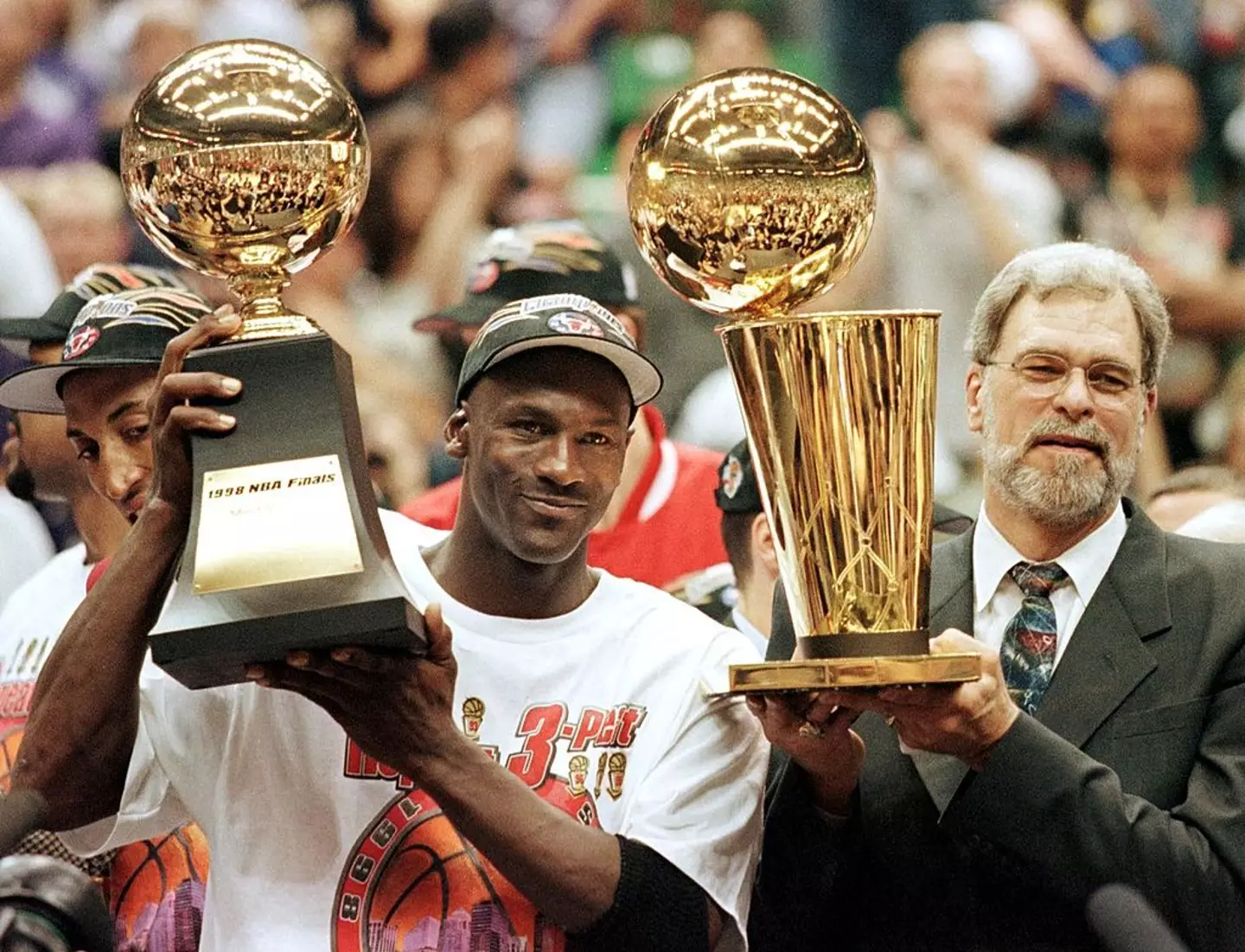 Michael Jordan celebrates with Chicago Bulls coach Phil Jackson after winning the 1998 NBA Finals (
