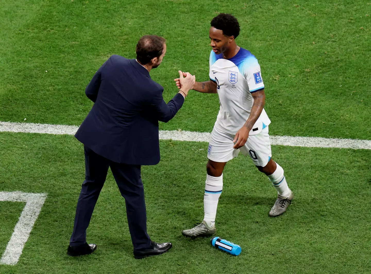 Sterling embraces Southgate after being substituted against Iran. (Image
