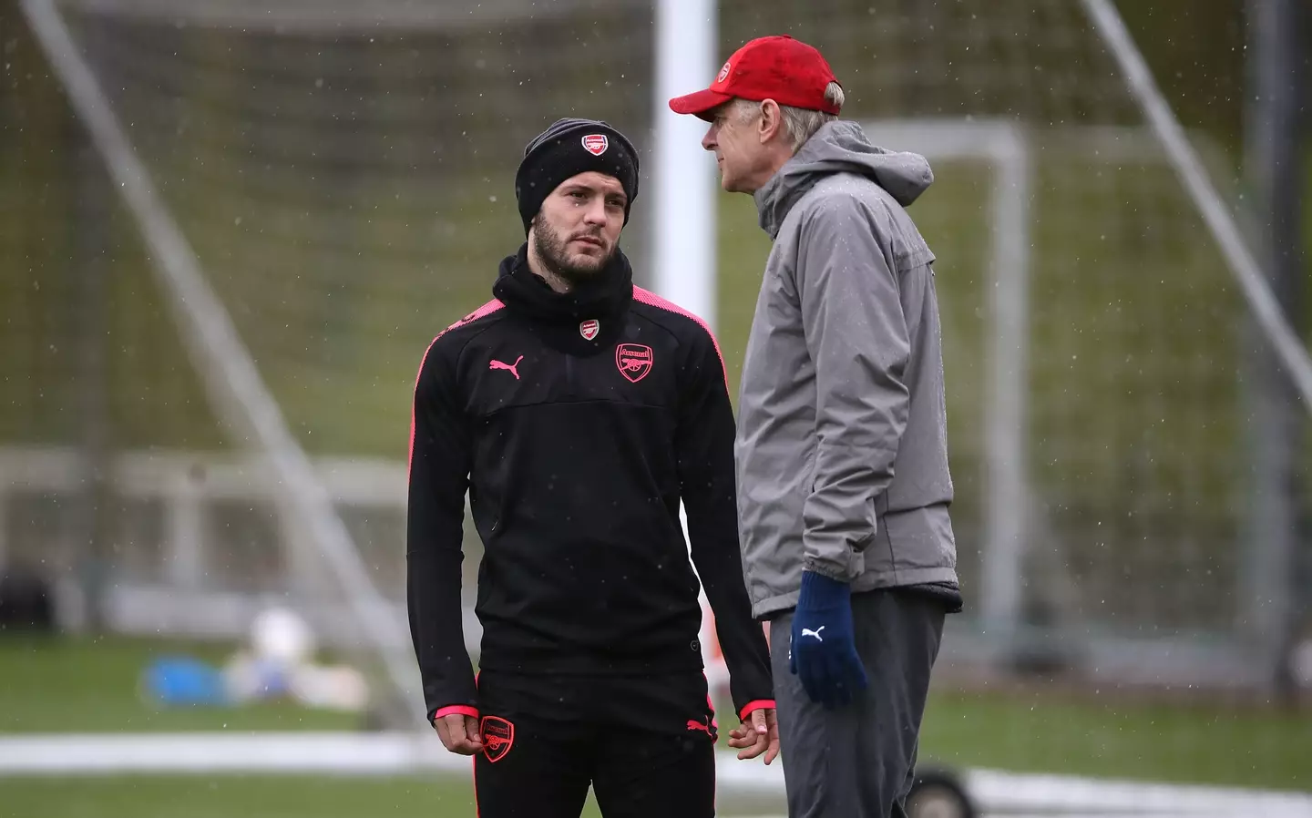Jack Wilshere talks to former boss Arsene Wenger at training.