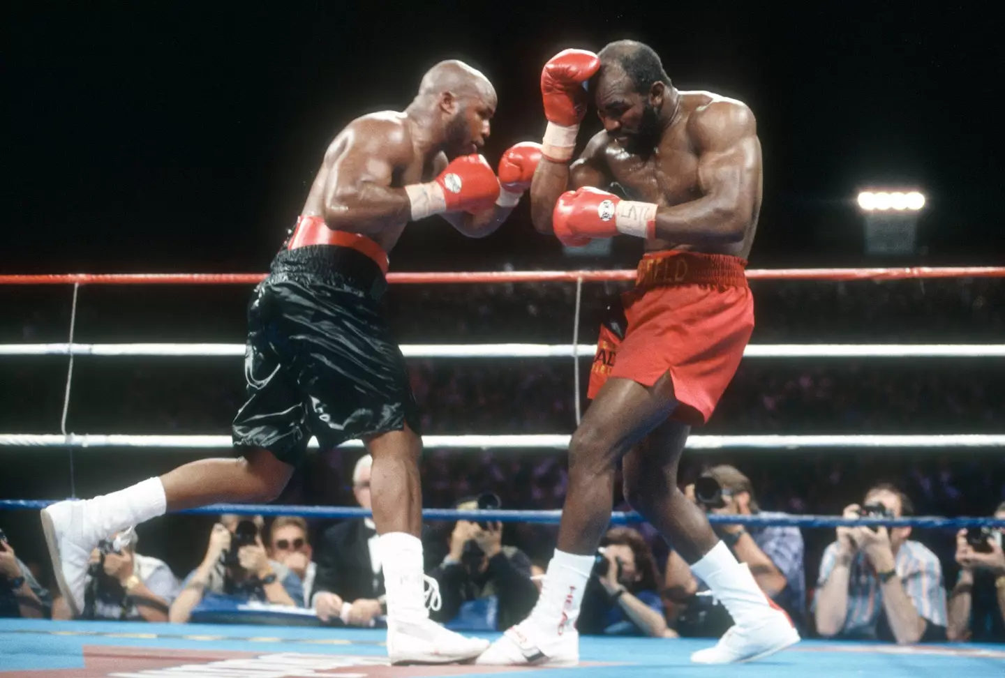 Evander Holyfield and Michael Moorer during their world title fight. Image: Getty