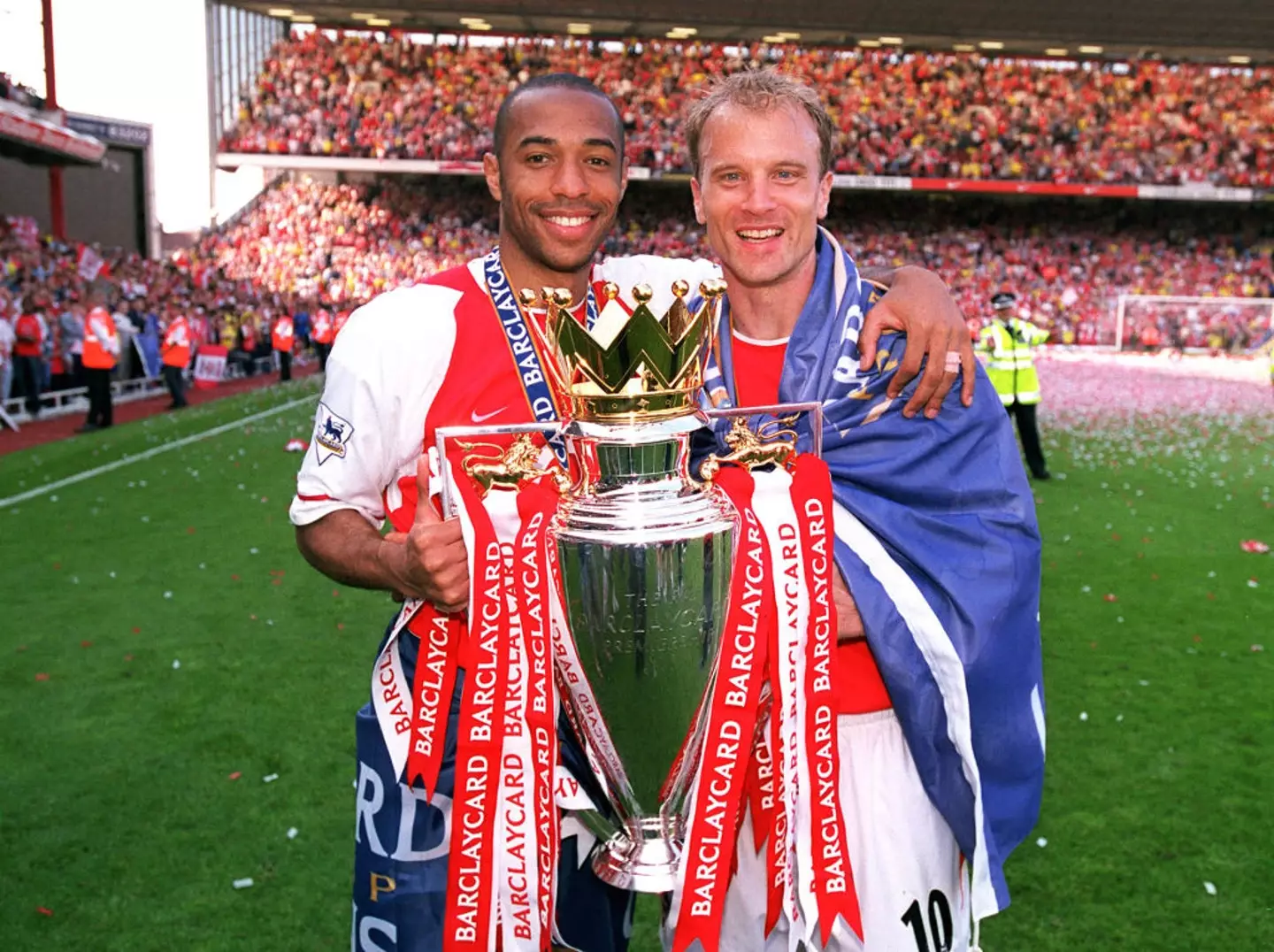 Dennis Bergkamp and Thierry Henry celebrate after winning the Premier League in 2004 (