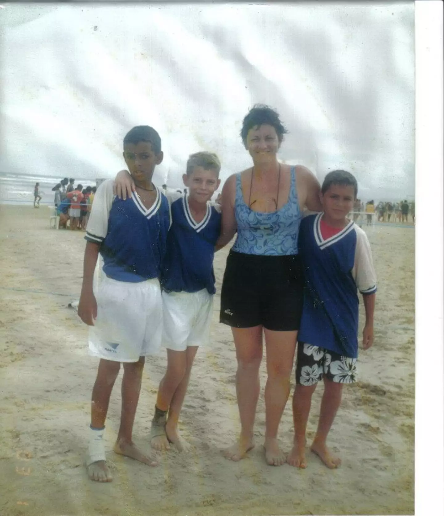 Jorginho, second left, with his mother on the beach. Image credit: Facebook/Jorginho Frello Official