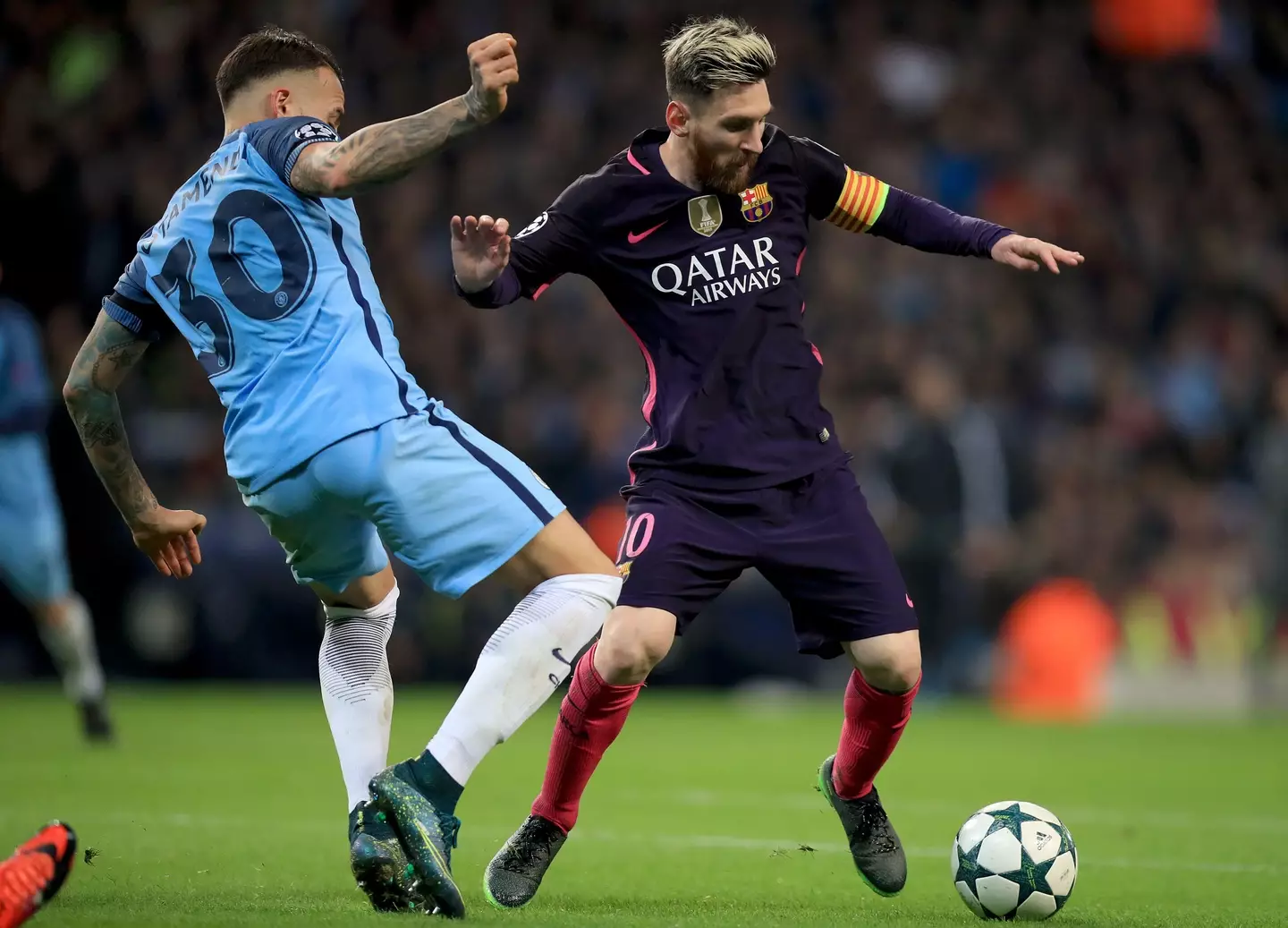 Messi is challenged by Otamendi. (Image