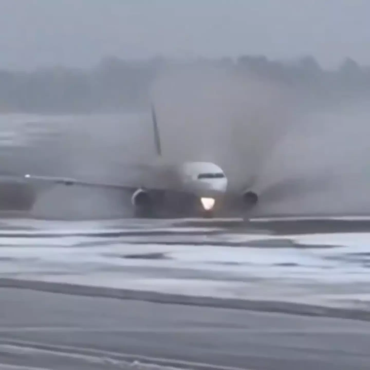Terrifying moment passenger plane skids through mud after landing on icy runway