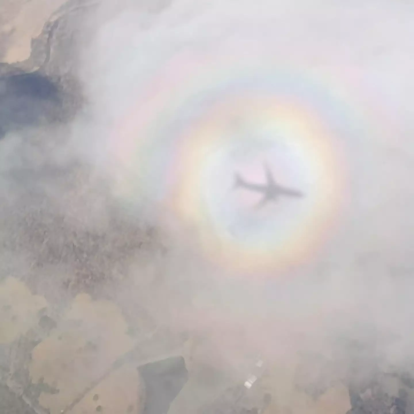 Woman takes ‘crazy’ photo of plane surrounded by rainbow in rare phenomenon known as 'pilot's glory'