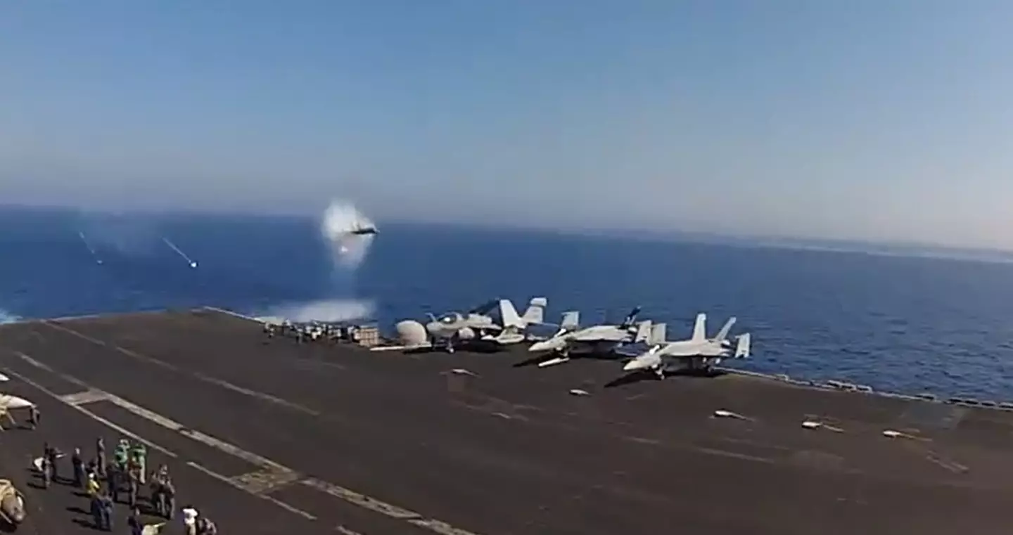 The F-18 flying by as it breaks the sound barrier.
