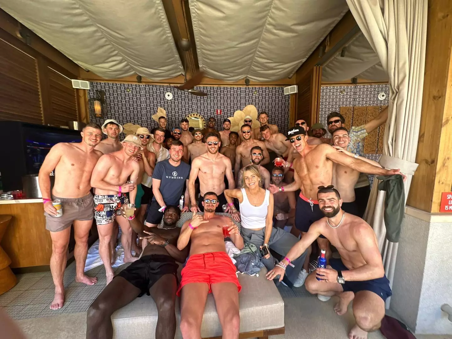 Rob McElhenney (second right in the cap) has show up Wrexham players after looking more ripped than any of them during the Las Vegas pool party.