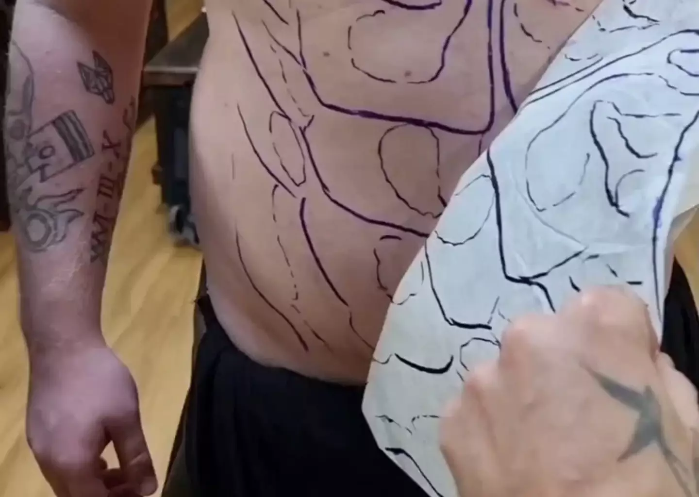 Tattoo artist Dean planned out how he'd give his happy customer a great looking six-pack.