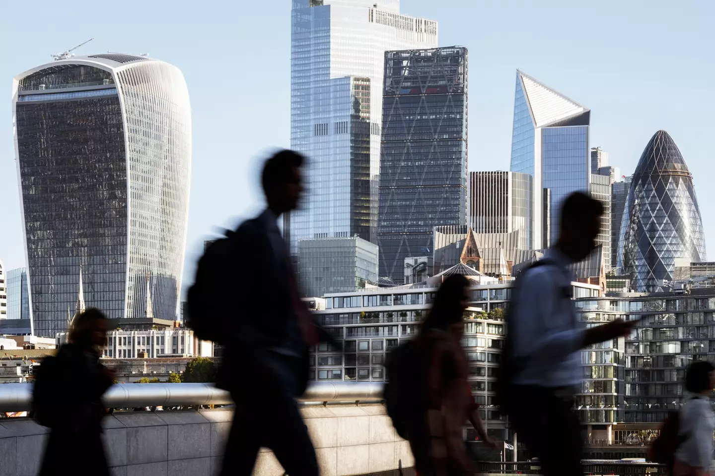 London business people walking to work with view of the financial district behind (Getty Stock Images)