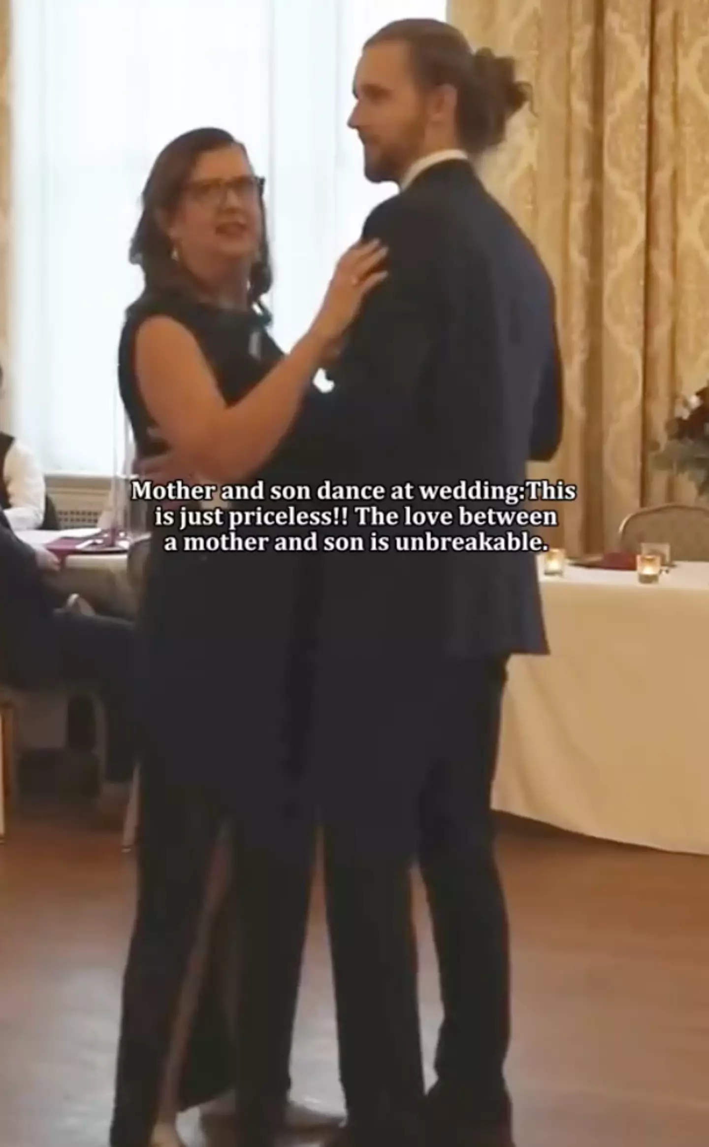 The mum and son are dancing at the wedding before the music changes.