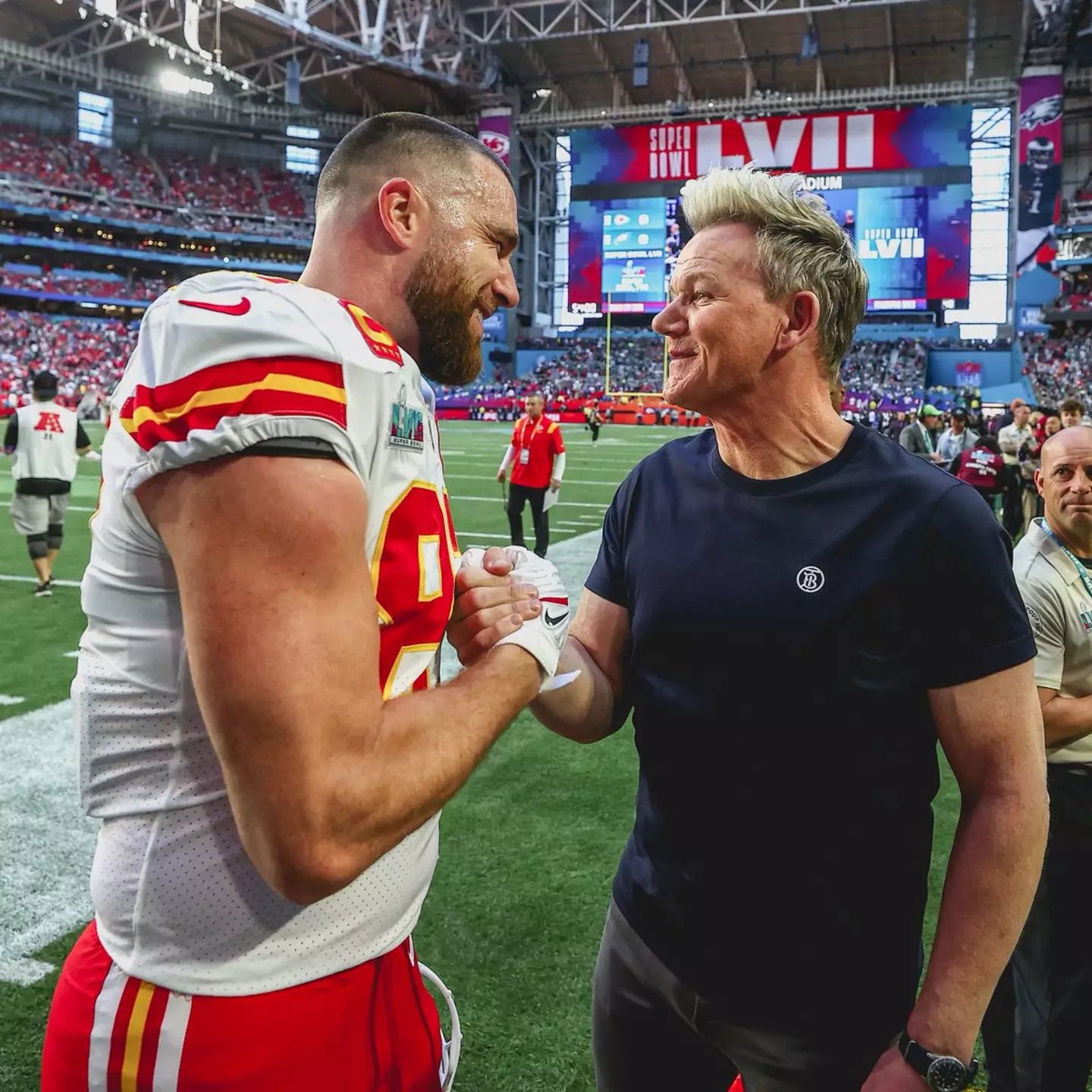 Travis Kelce and Gordon Ramsay embraced in a handshake.