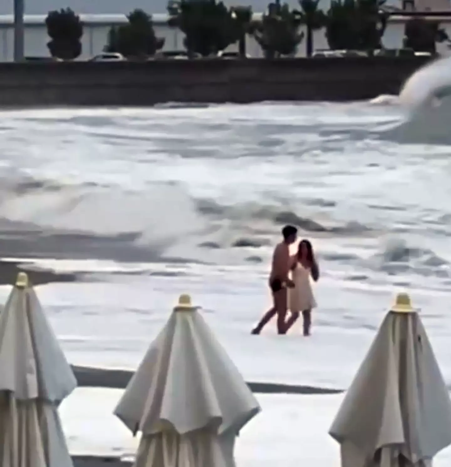 A video of a woman being swept away in the ocean has been shared online. (Newsflash)