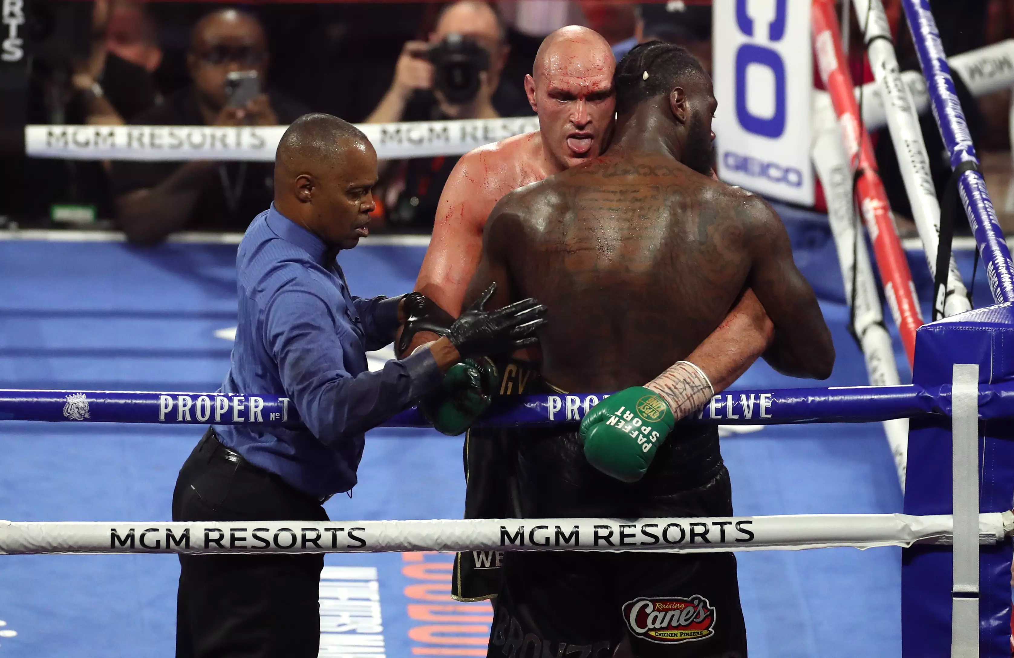 Tyson Fury pretends to lick Deontay Wilder's blood during their second bout.