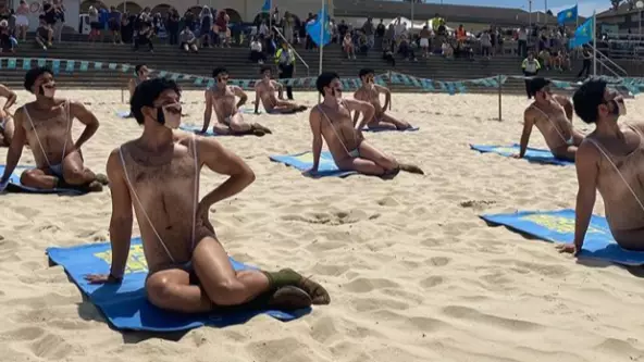 Forty Men In 'Maskinis' Crash Bondi Beach In Borat 2 Stunt