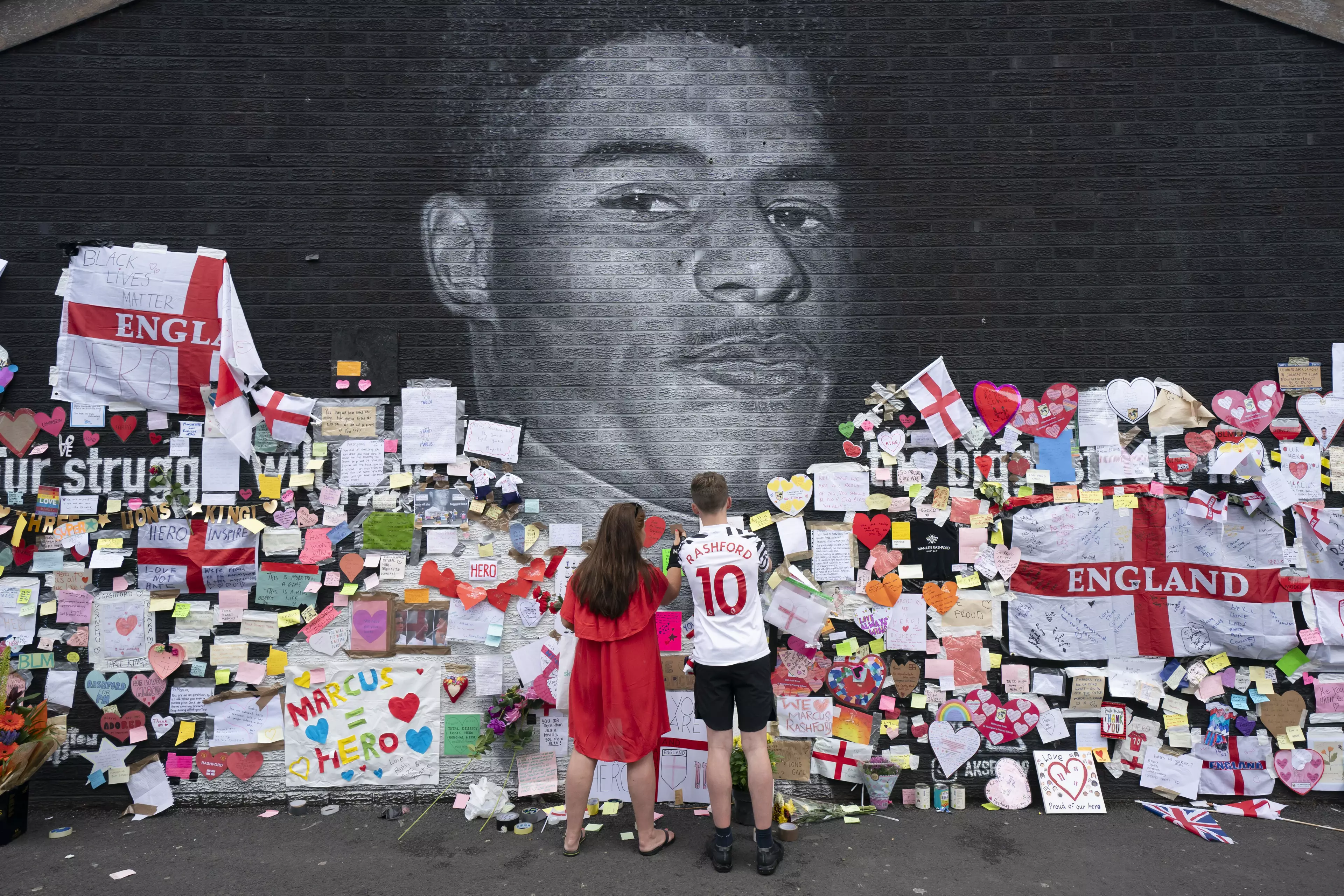 Fans decorate Marcus Rashford's mural after it was defaced. Image: PA Images