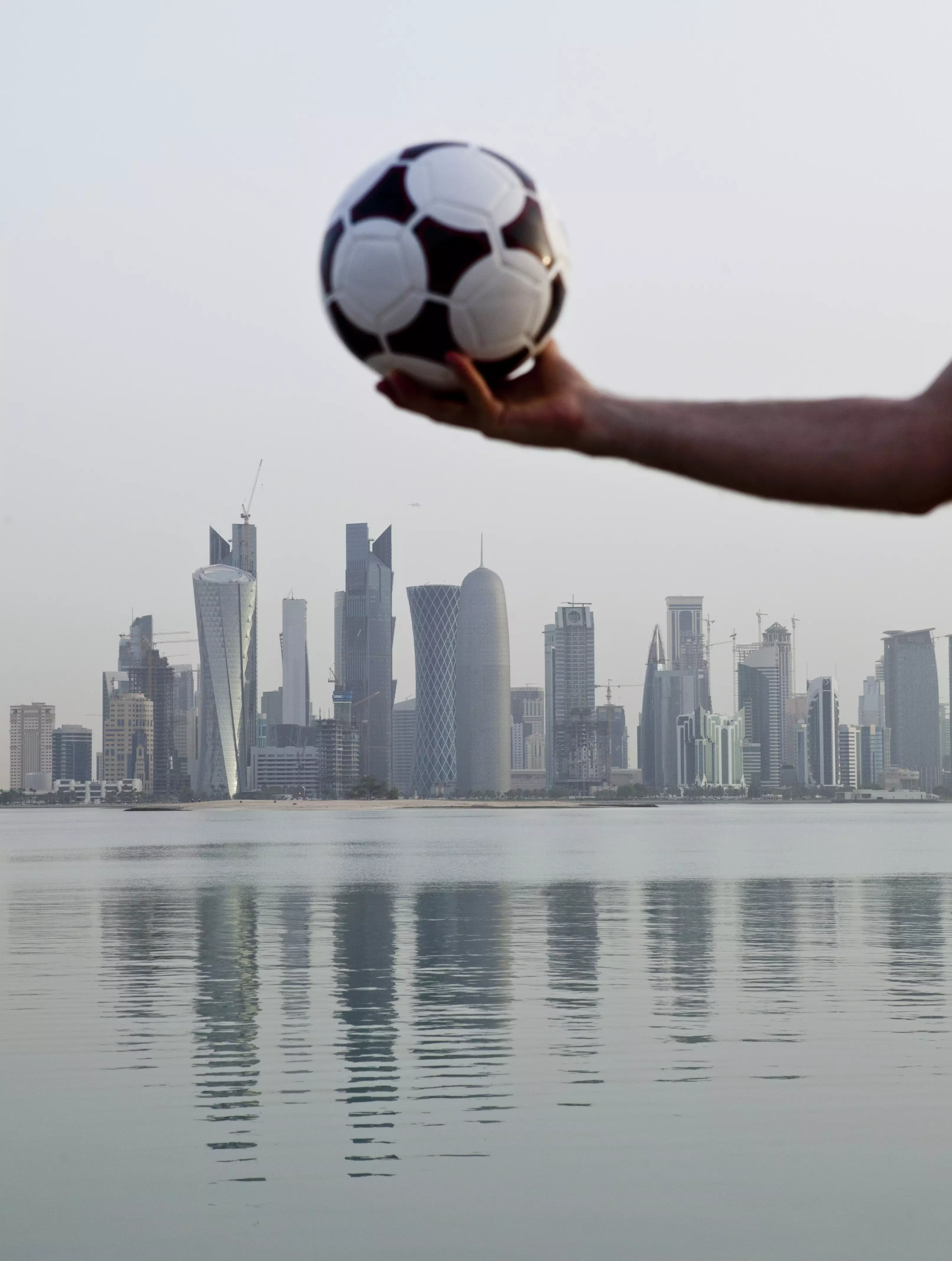 A visual metaphor hangs above the city of Doha.