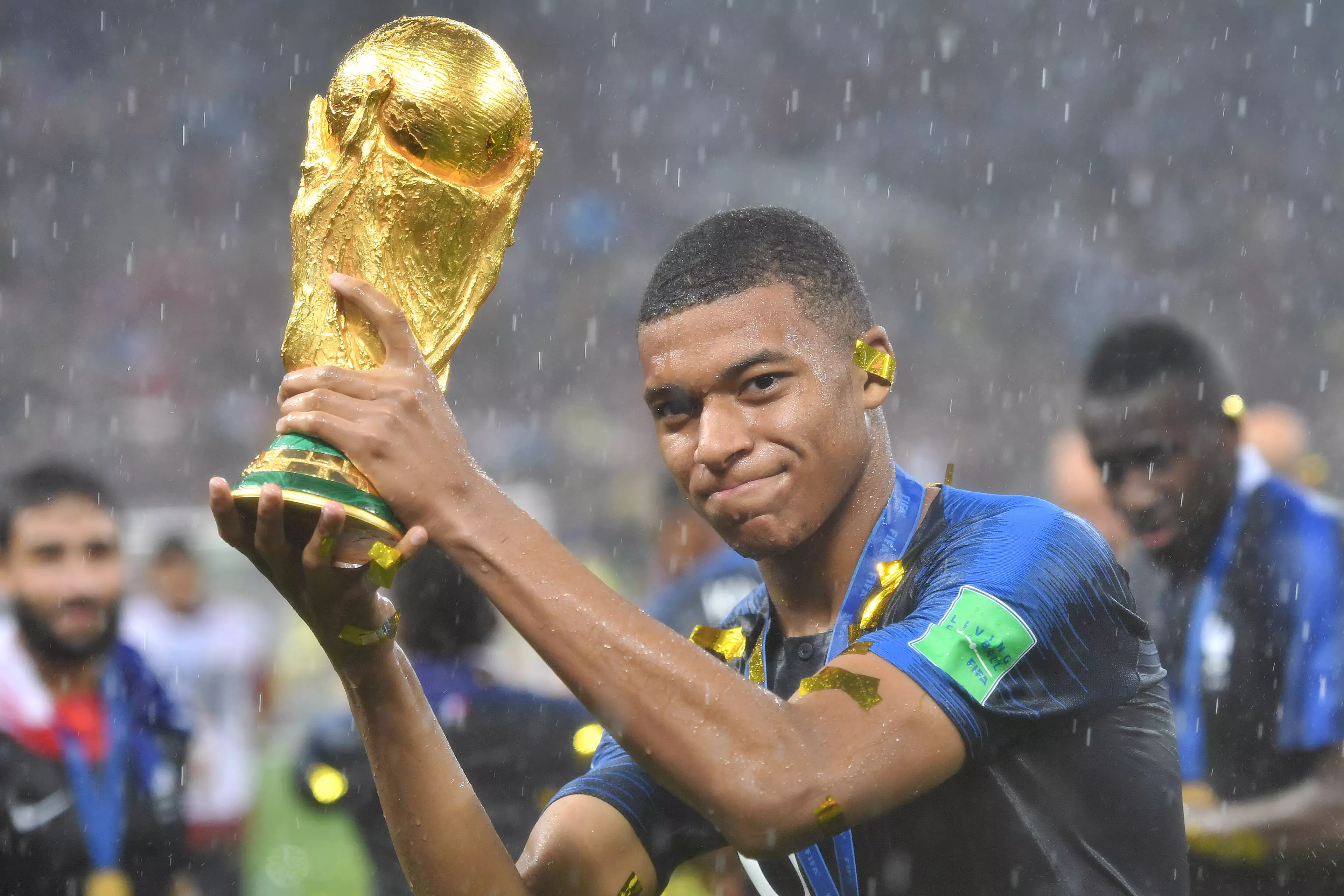 Mbappe with World Cup trophy.