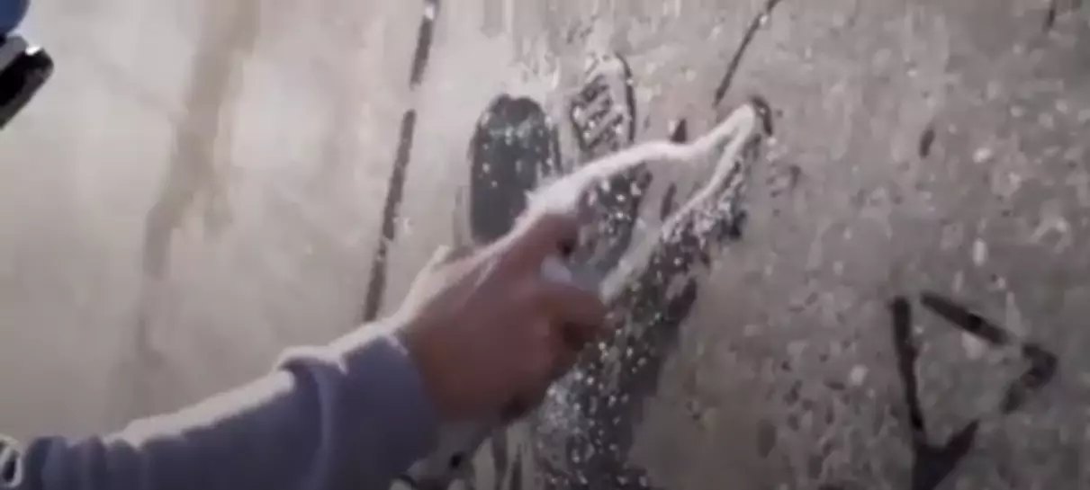 Footage of Banksy creating the mural.