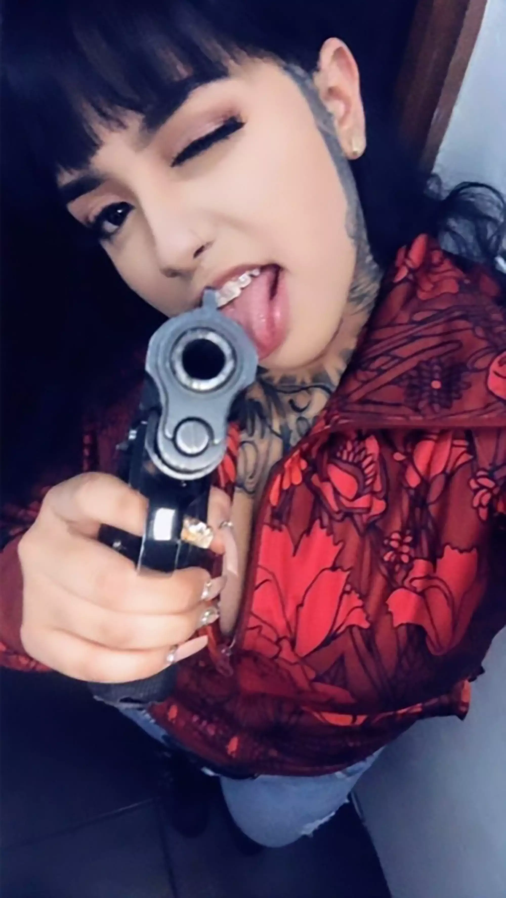 A photo of Keilanny Boo with a gun.