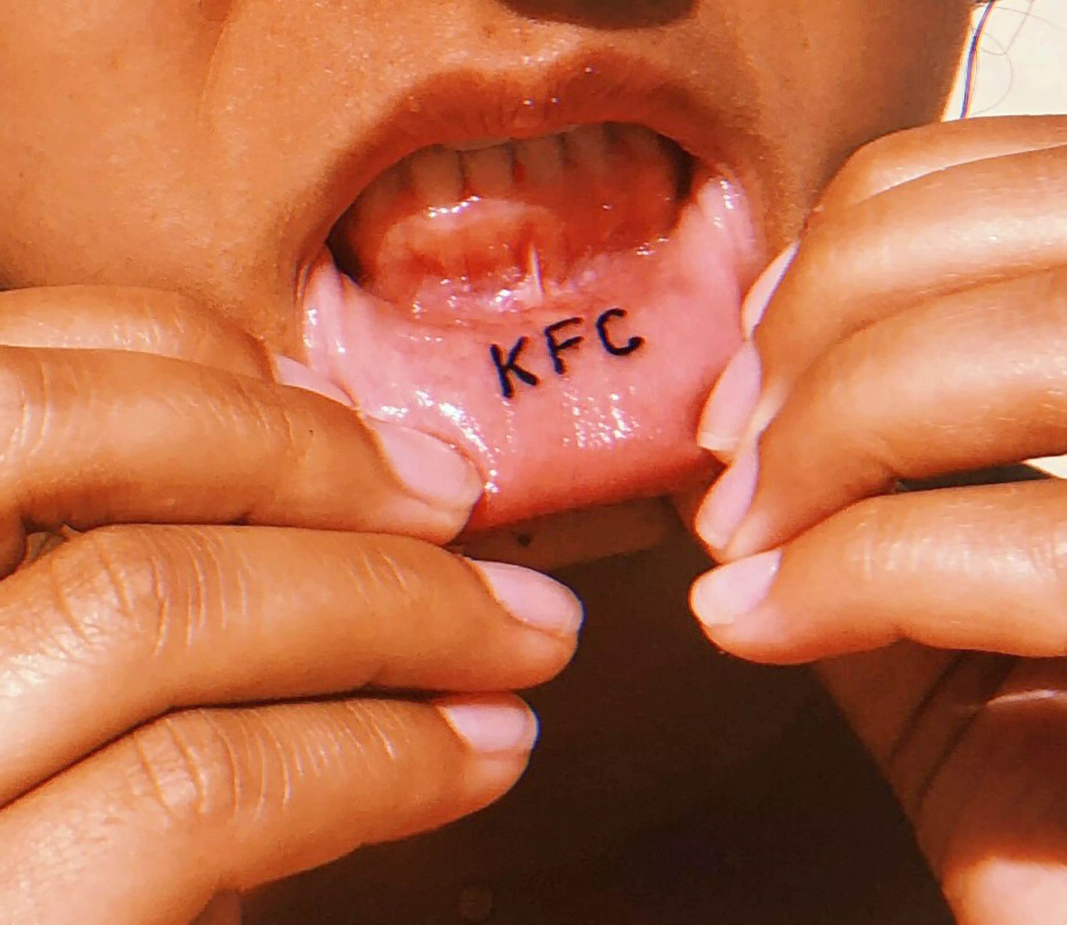 Tabatha Andrade got 'KFC' tattooed on her lip.