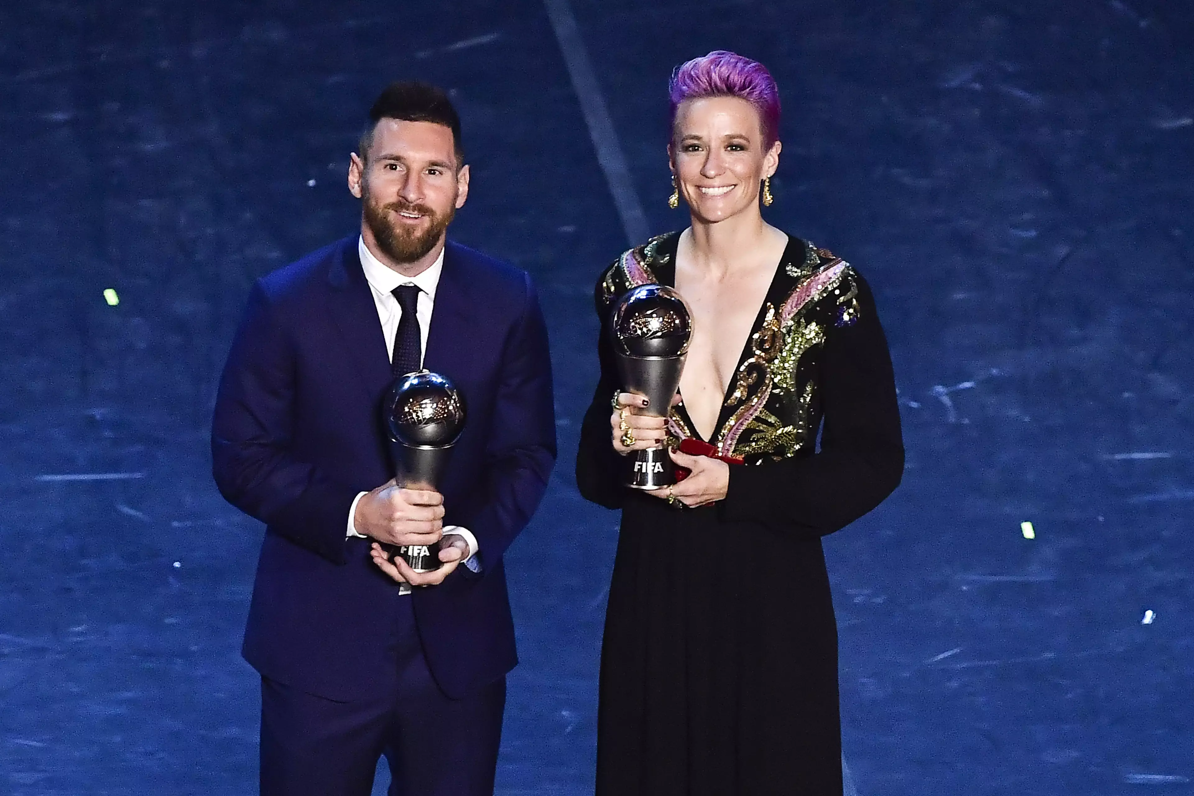 After running away from the red carpet Messi collects his award alongside Megan Rapinoe. Image: PA Images