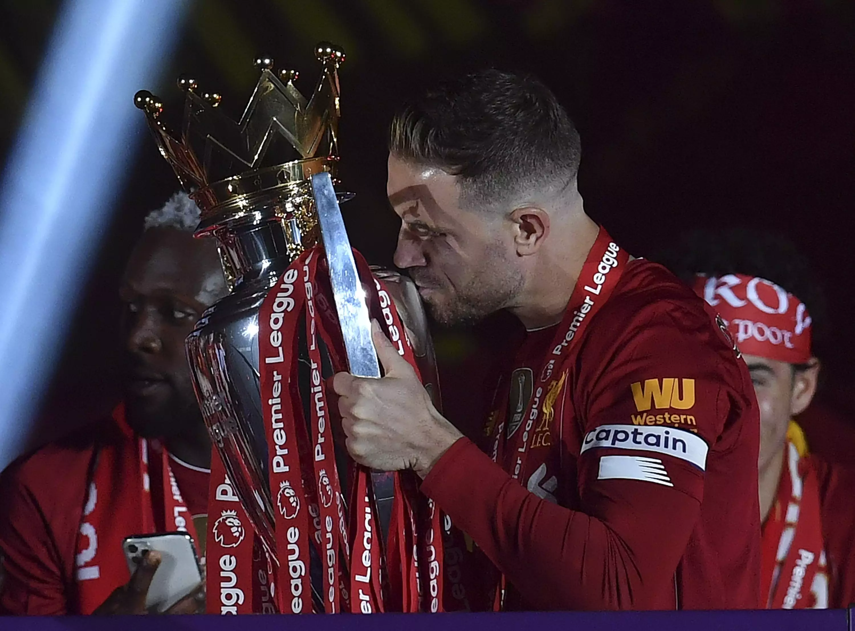 Henderson kisses the Premier League trophy before lifting it. Image: PA Images