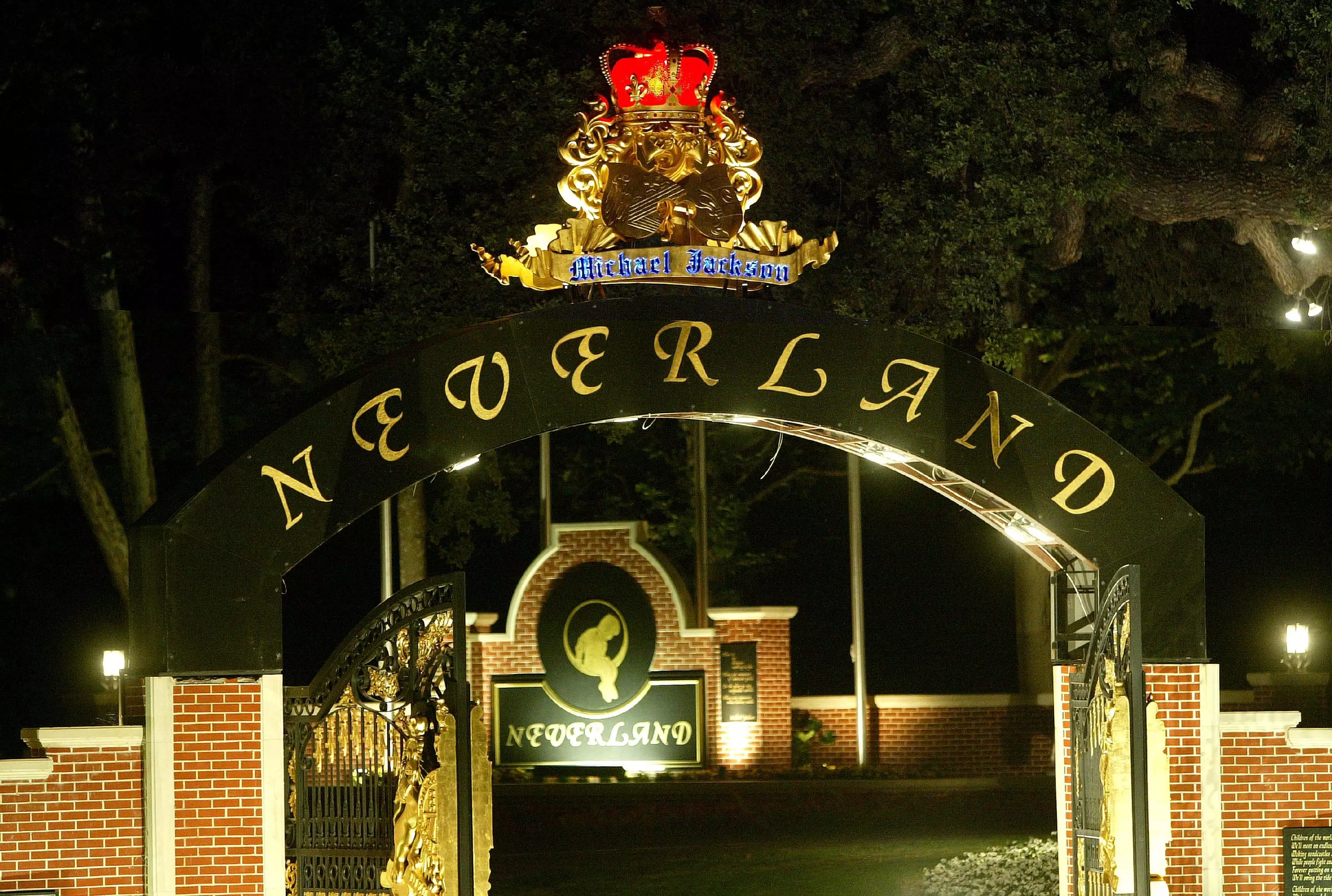 Neverland Ranch lit up in the evening.