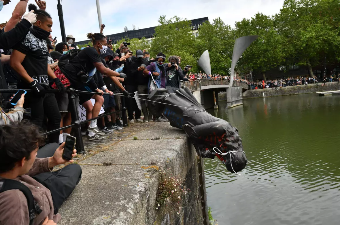 Protesters throw statue of Edward Colston into the Bristol harbour.