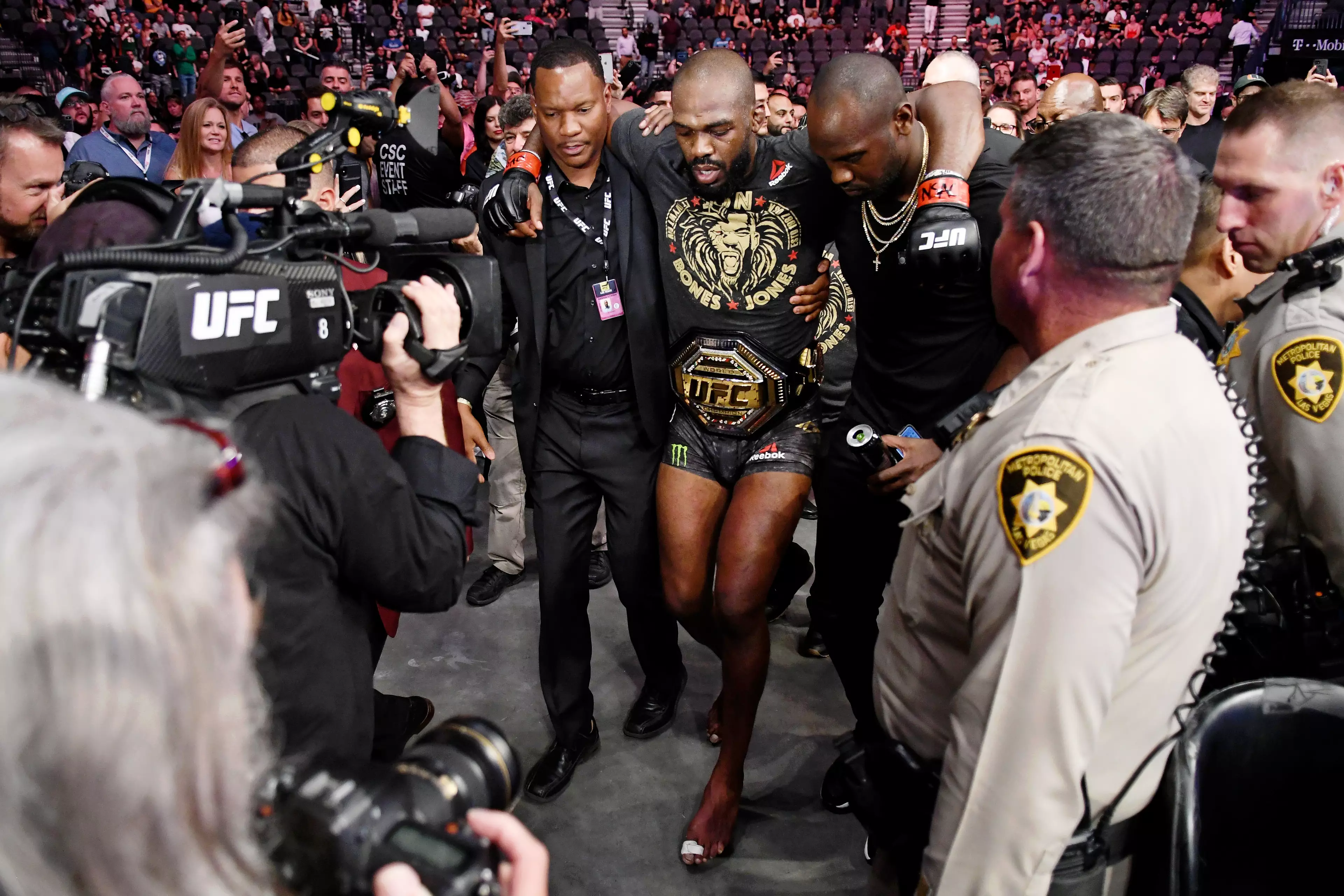 Jones is carried out of the octagon following his fight with Thiago Santos.