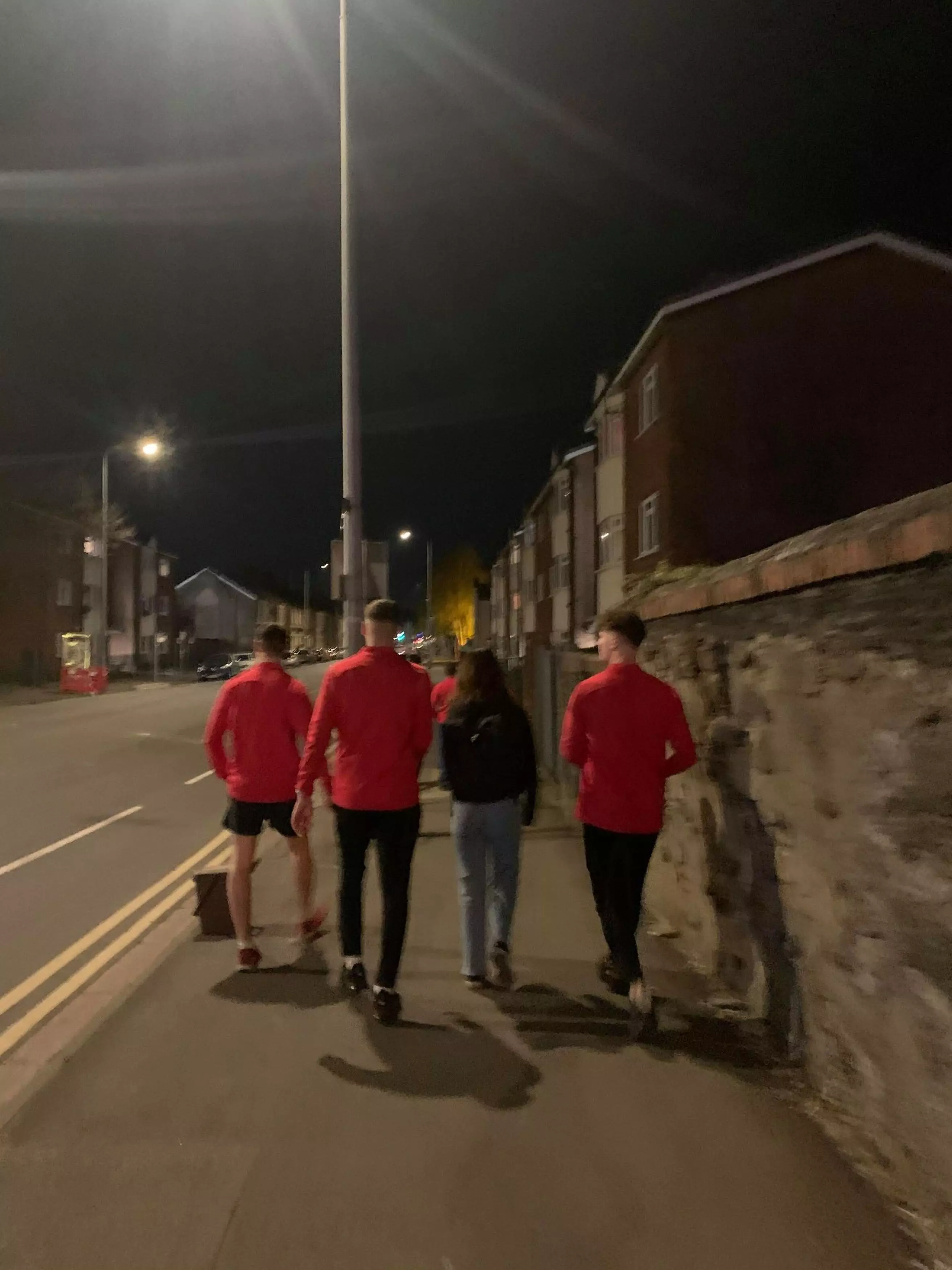 The lads walking a fellow student home.